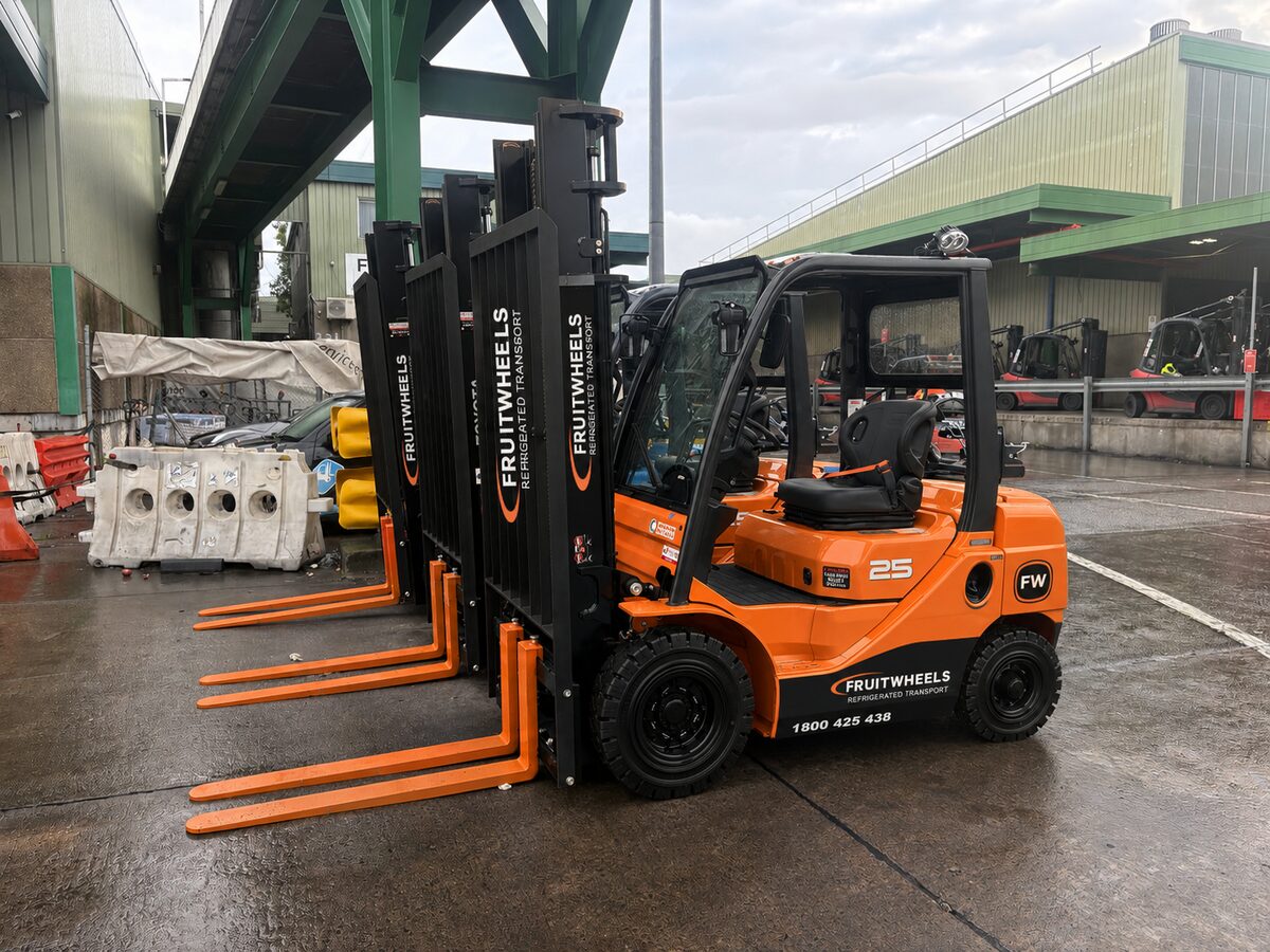 Fruit Wheels branded forklifts lined up at Sydney Markets